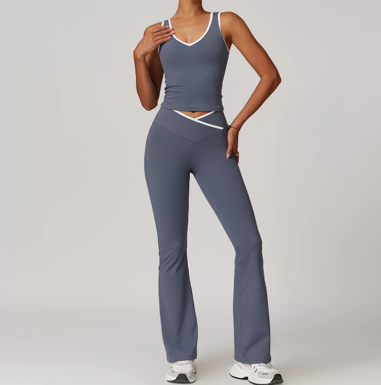 Person wearing a gray athletic outfit on a plain background