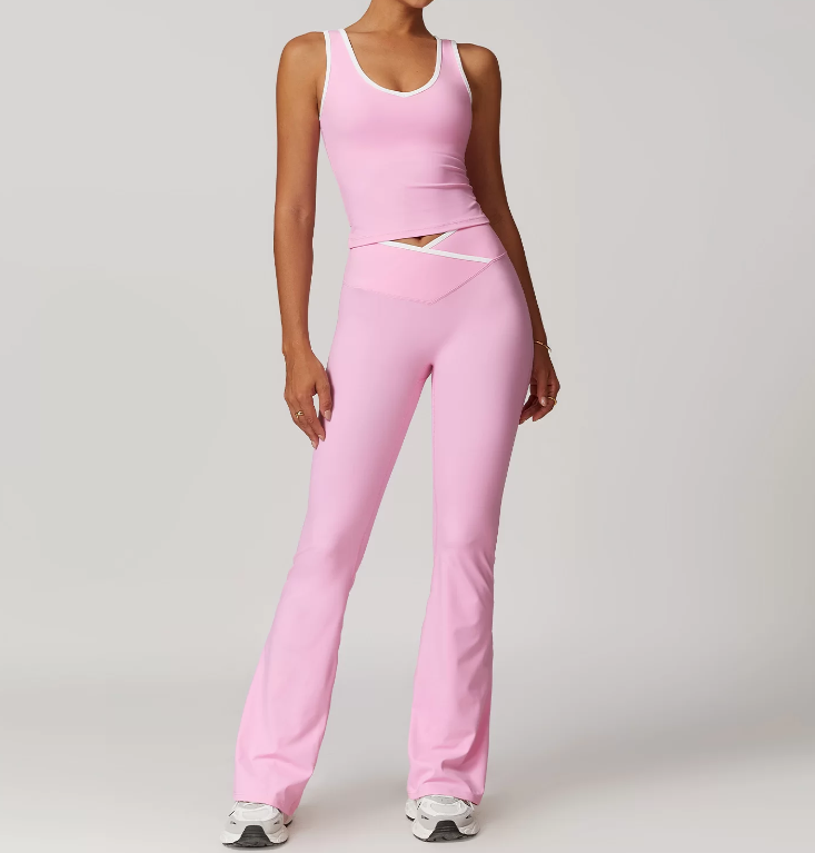 Person wearing a pink athletic outfit on a plain background