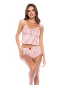 Woman wearing a pink checkered top and high-waisted shorts on a white background