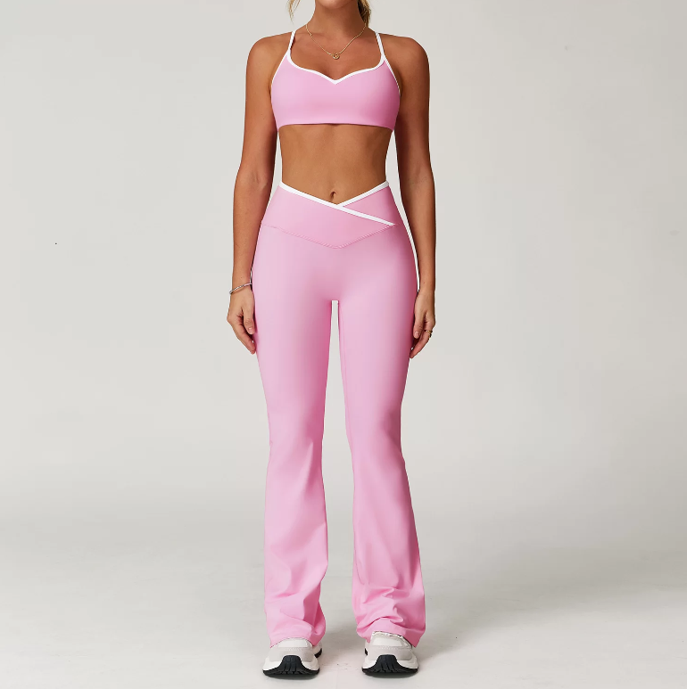 Person wearing a pink sports bra and leggings set on a plain background